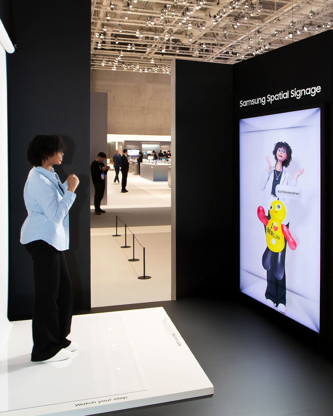 Visitor viewing her life-size cartoon character on Samsung Spatial Signage
